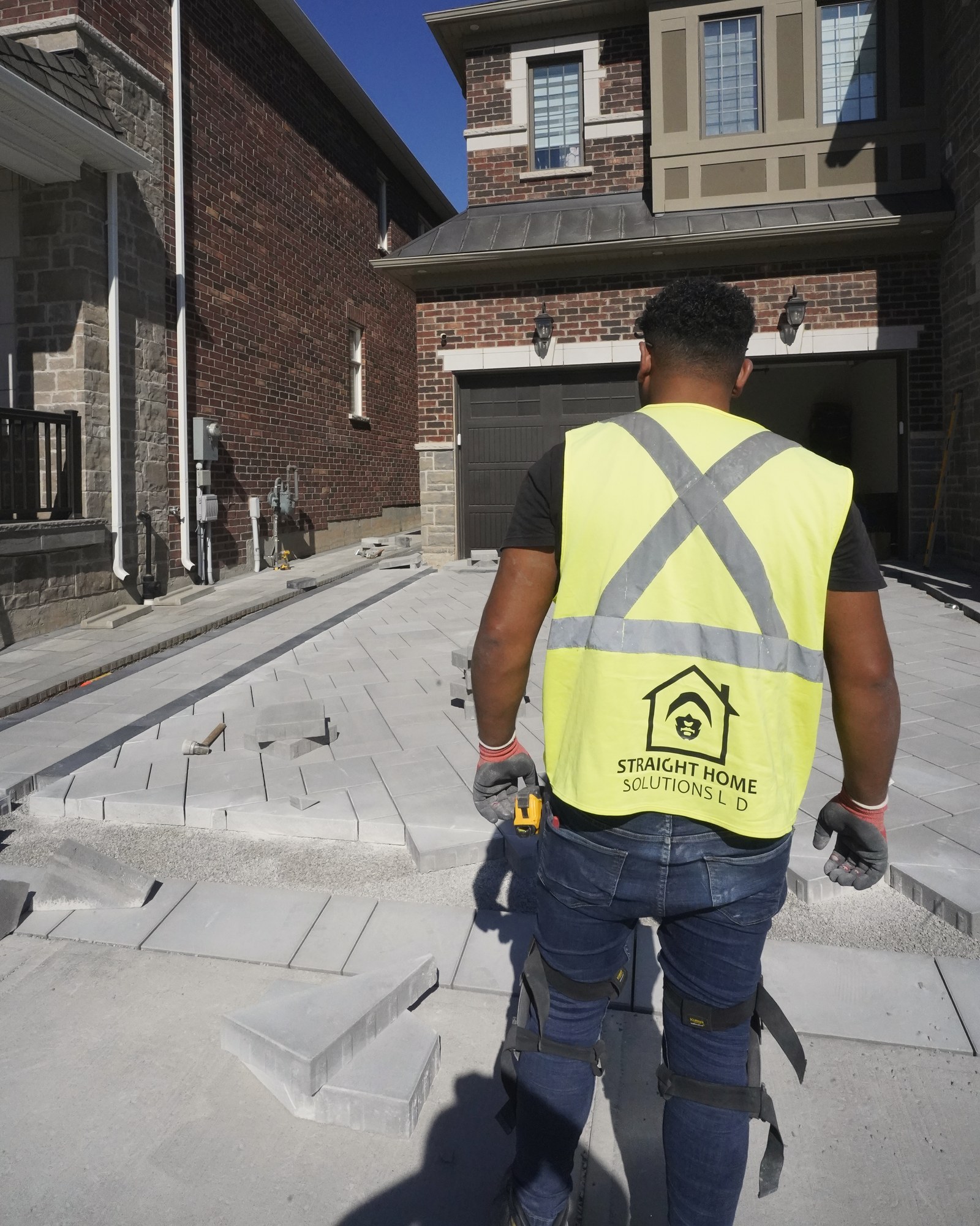 Straight Home Solutions crew member reviewing an active interlocking installation