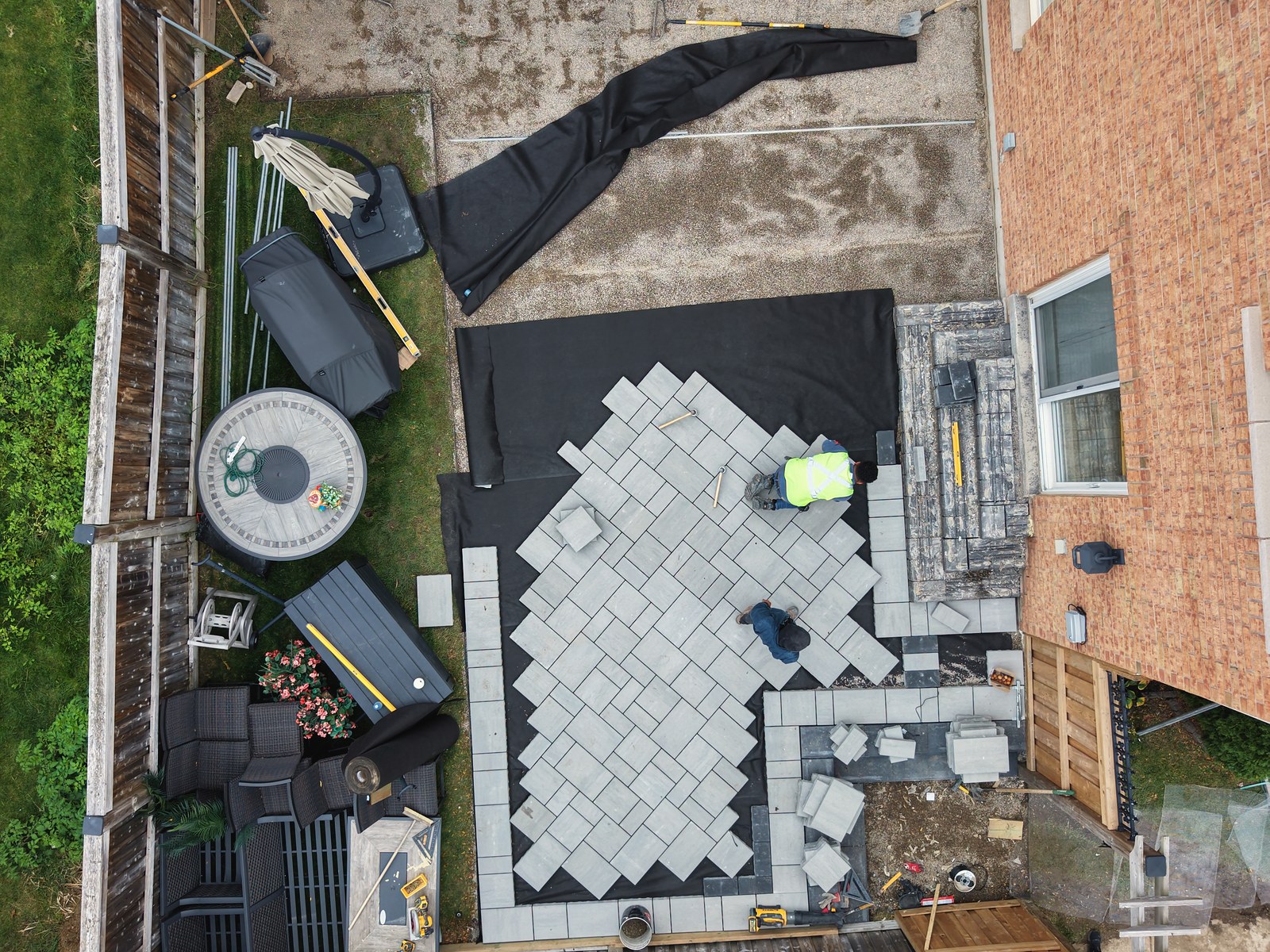 Overhead view of pavers being placed during an outdoor construction project