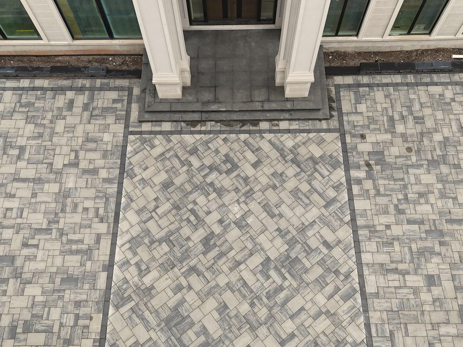 Detailed overhead view of paver patterns and contrasting border materials