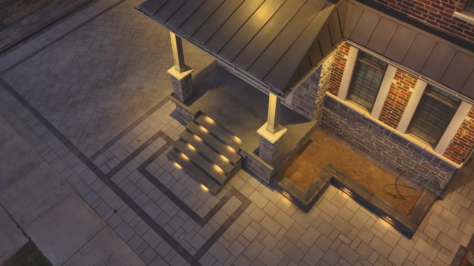 Completed interlocking entrance with illuminated steps and contrasting stone borders