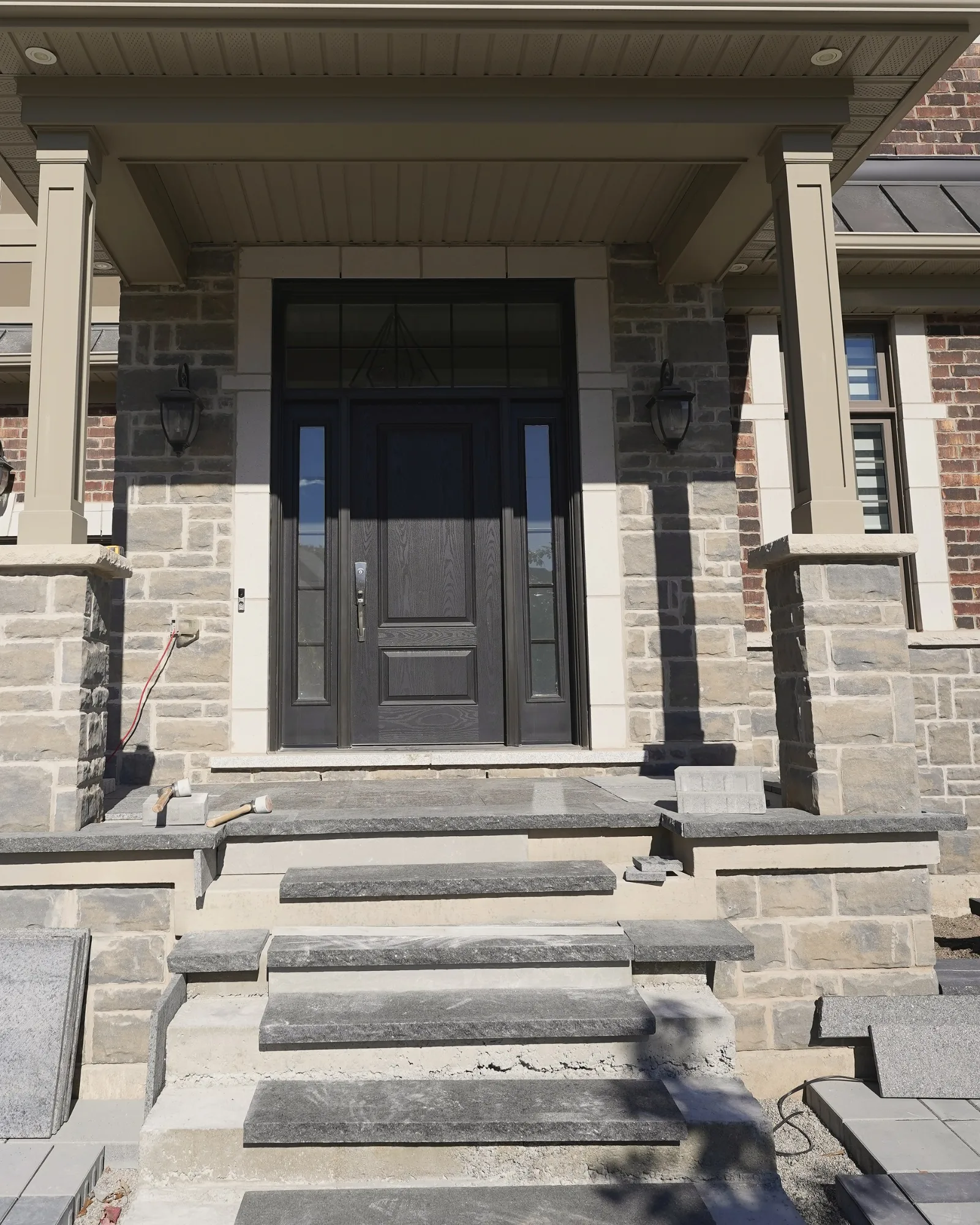 Front entrance steps and interlocking borders taking shape during construction